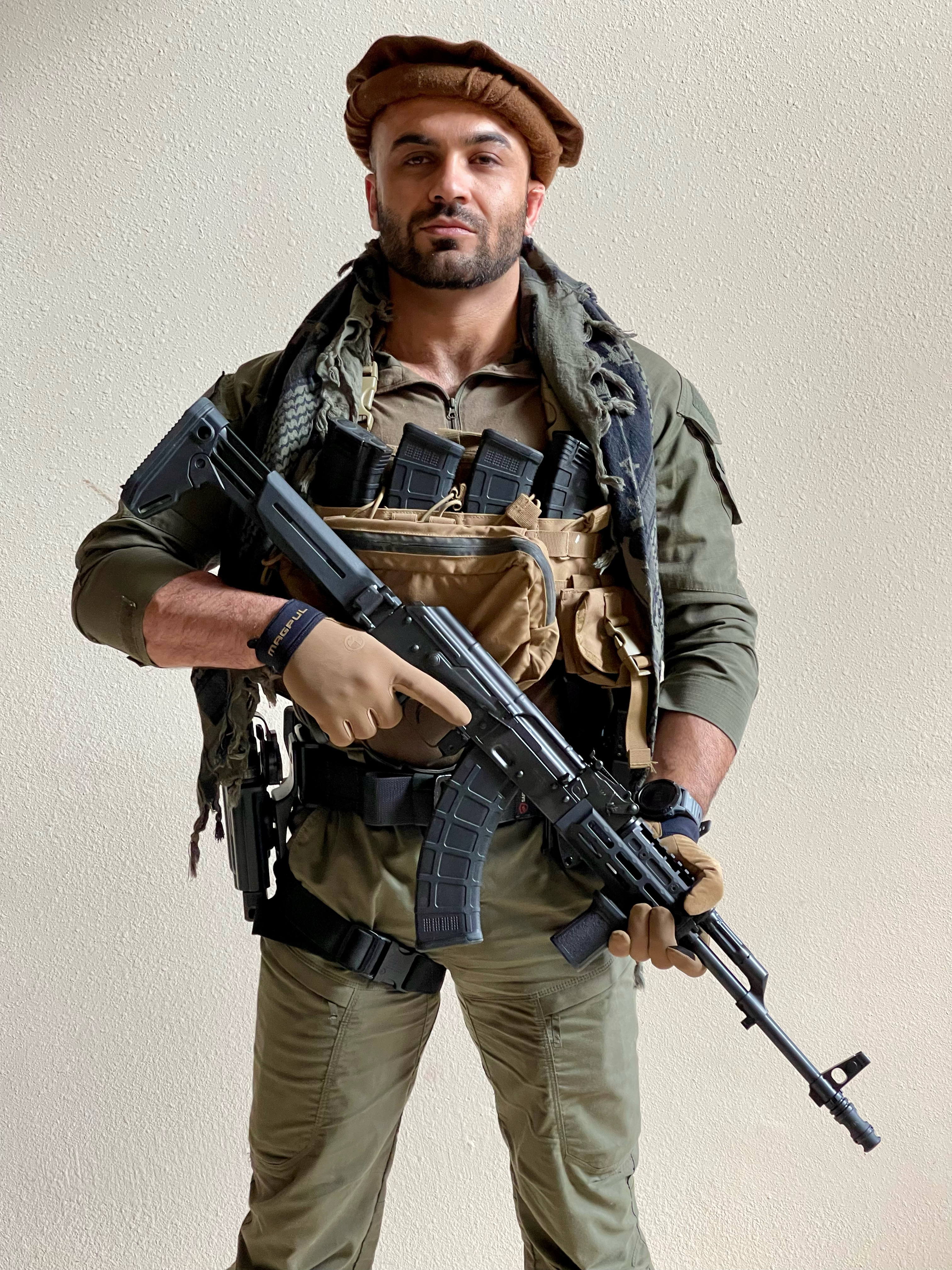 Jason Essazay in tactical wardrobe with weapons for film production weapon master work